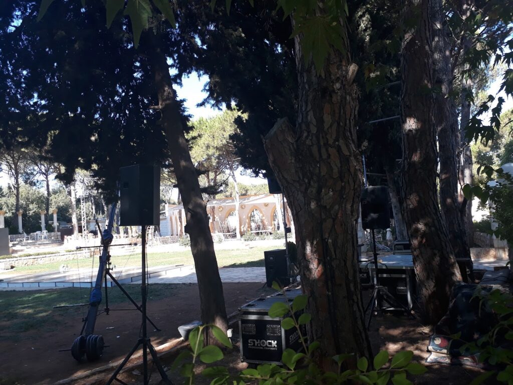 a group of speakers and a stand in a park