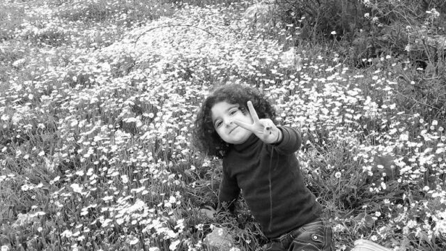 a child sitting in a field of flowers