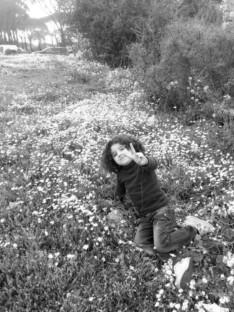 a child sitting in a field of flowers