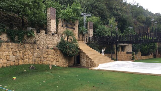 a stone wall with a bridge and a walkway