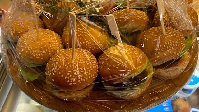 A basket of Khoury Kitchen burgers, wrapped in plastic.