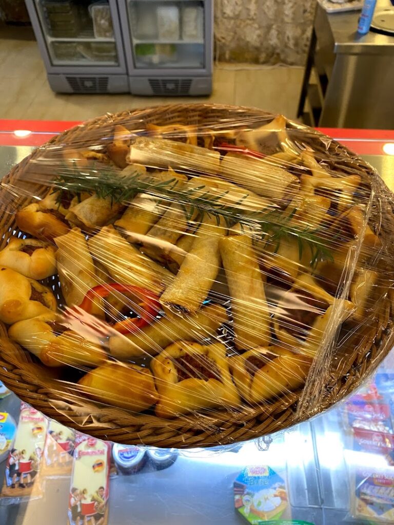 a basket of food wrapped in plastic from Khoury Kitchen.