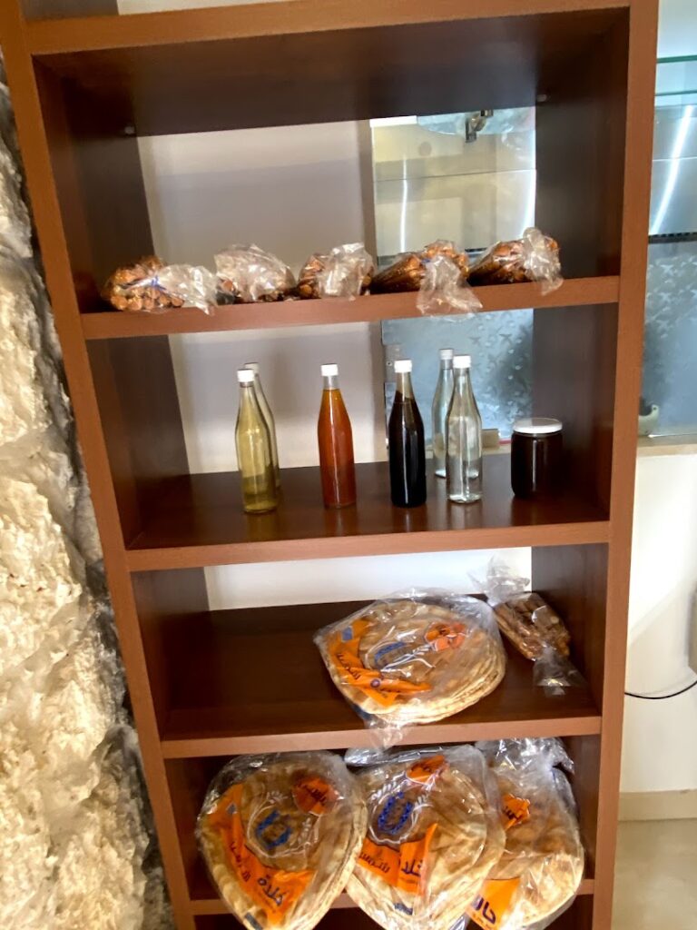 In Khoury Kitchen, there is a shelf with a variety of food and drinks on it.
