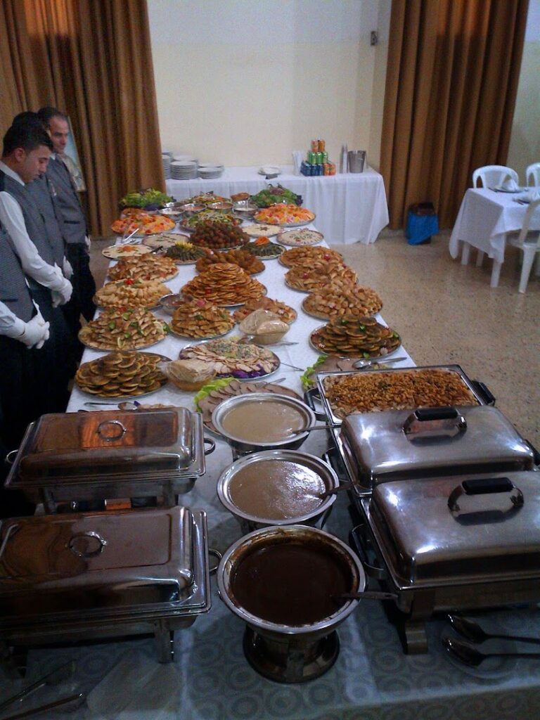 A buffet table full of food catered by La Paella Catering.