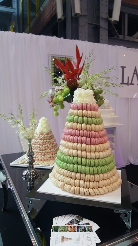 A pyramid of macaroons from Larissa Catering on a table.