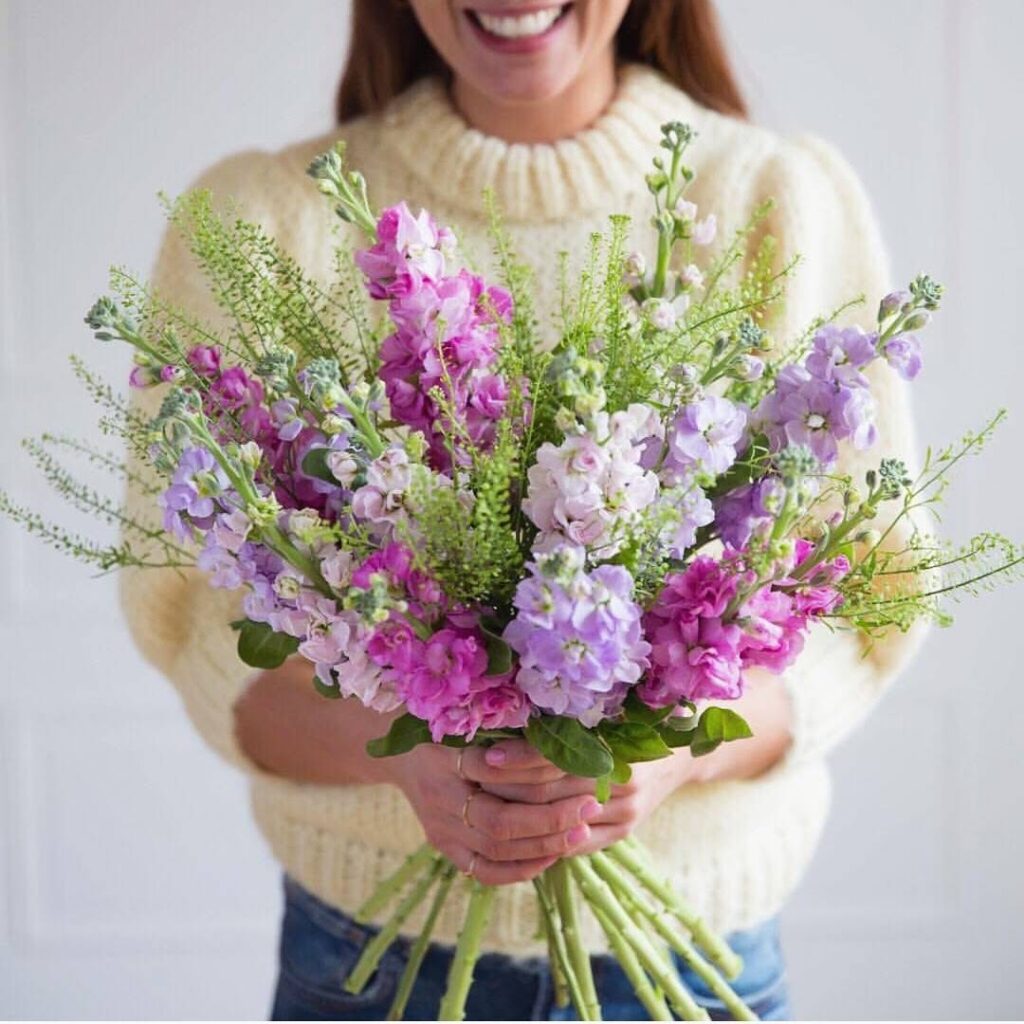 a woman holding a bouquet of flowers