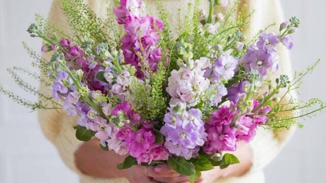 a woman holding a bouquet of flowers