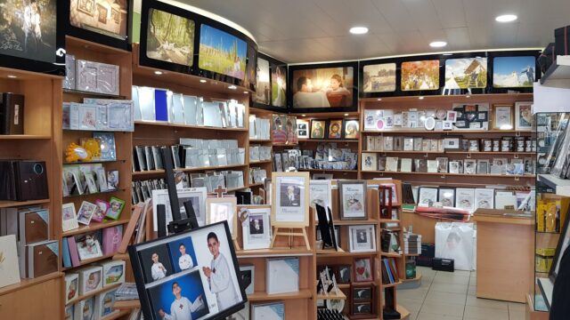 a store with shelves of pictures and frames