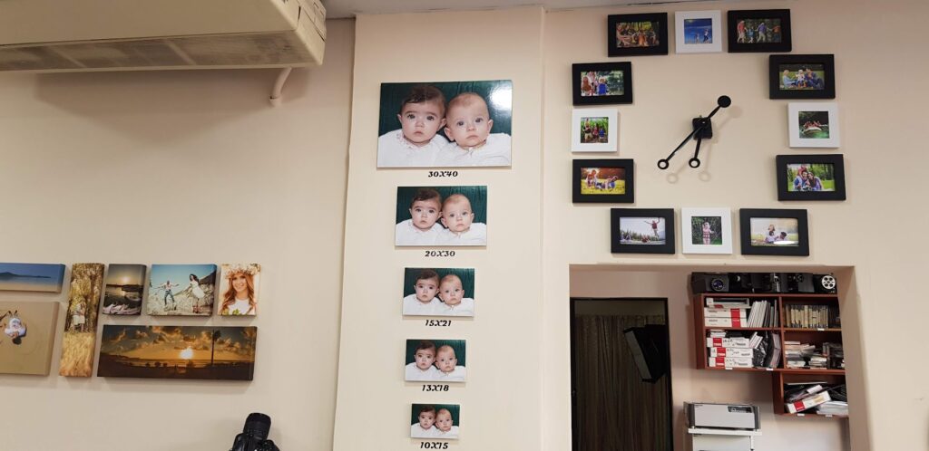 a wall with pictures of babies on it