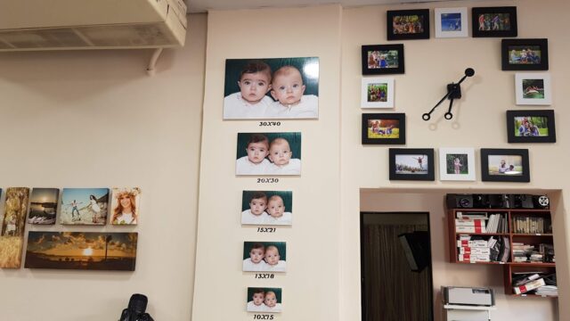 a wall with pictures of babies on it