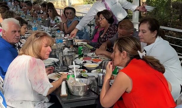 "A group of people sitting at a table at Lilium Venue & Restaurant."