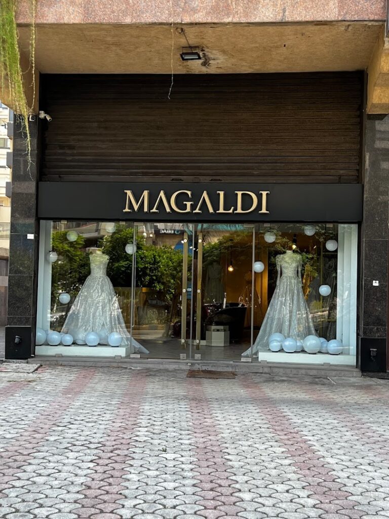 a store front with white dresses and balloons