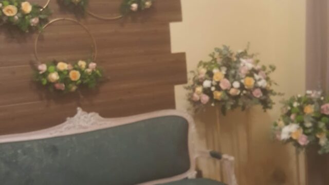 a couch and flowers on a wall