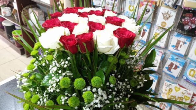 a bouquet of red and white roses