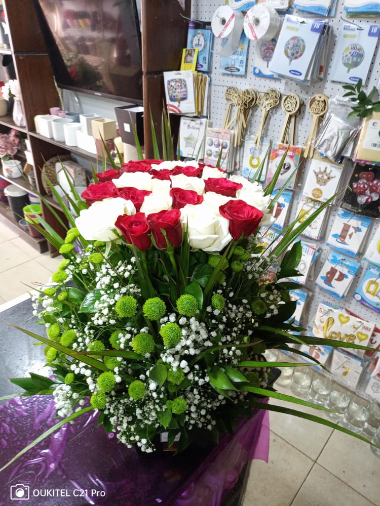 a bouquet of red and white roses