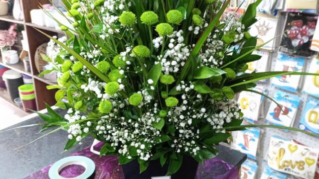 a bouquet of flowers in a black container