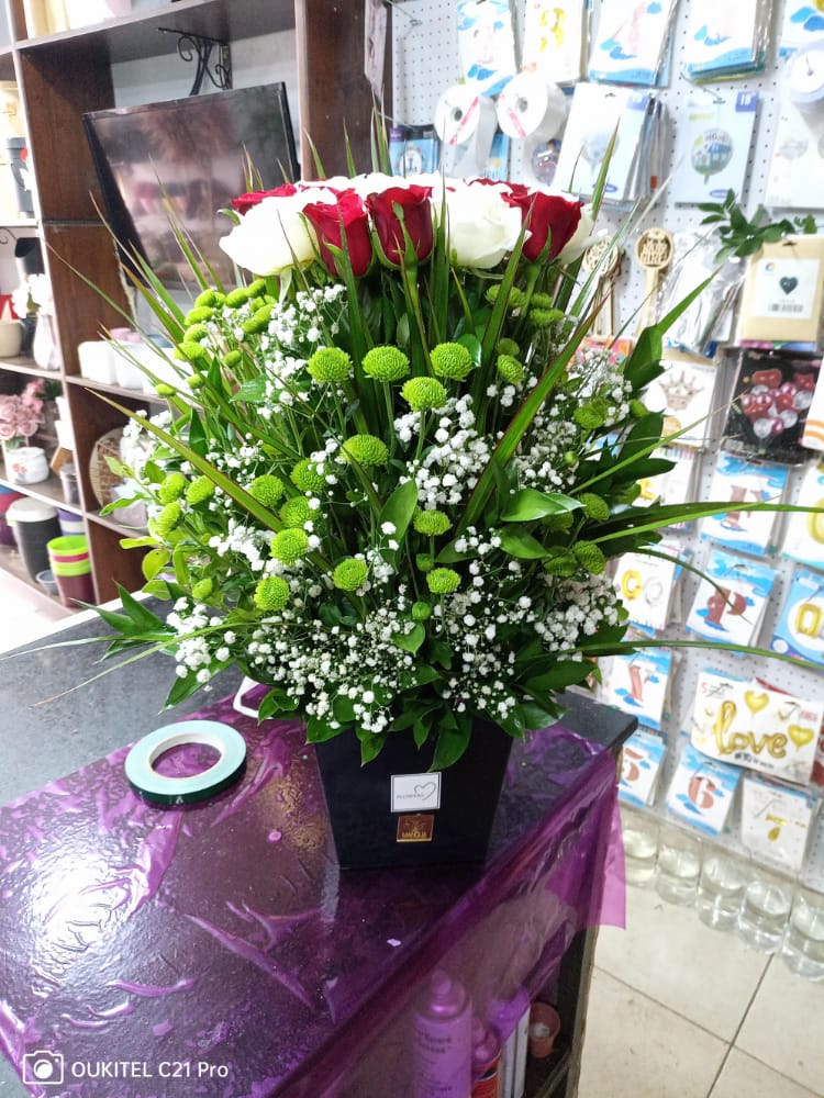 a bouquet of flowers in a black container