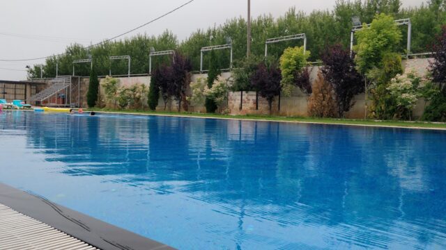 a pool with trees in the background