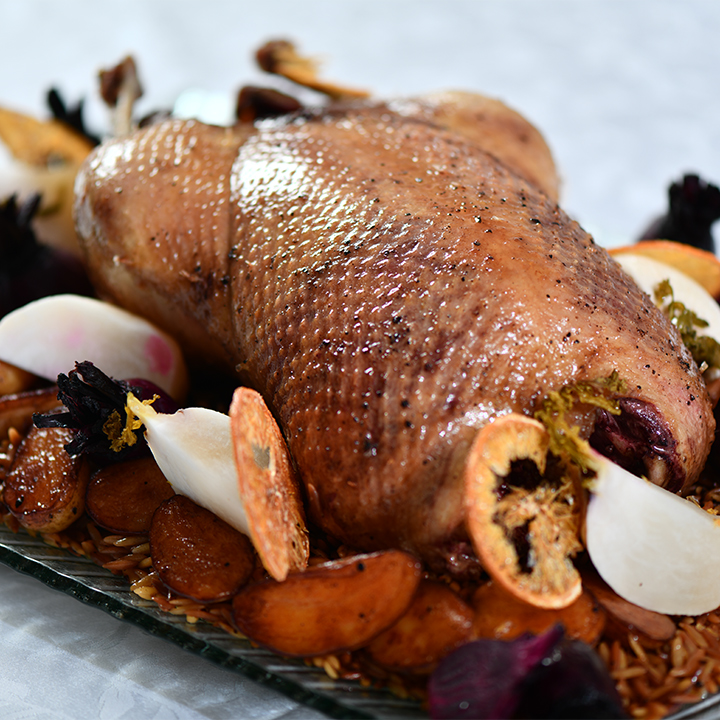 A roast duck with rice and vegetables prepared by Michael Catering.