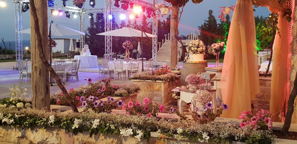 a outdoor wedding reception with tables and chairs