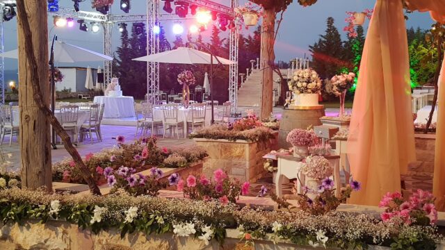 a outdoor wedding reception with tables and chairs