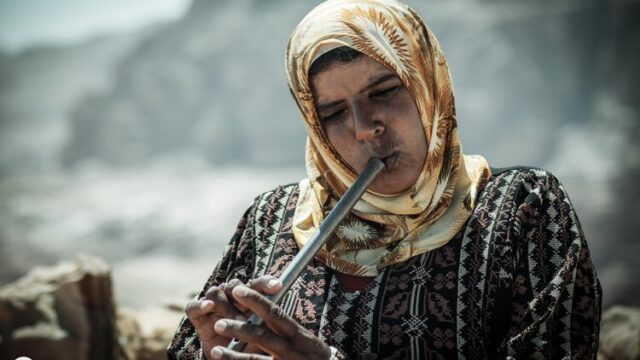 a woman playing a flute