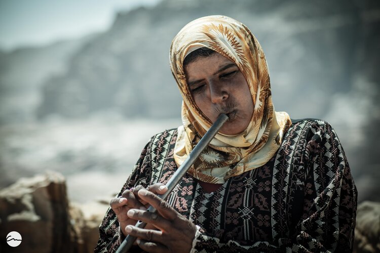 a woman playing a flute