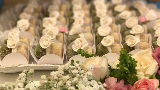 a tray of small desserts with flowers