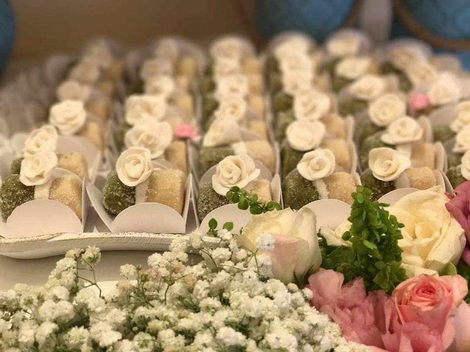 a tray of small desserts with flowers