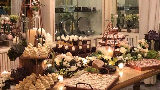 a table with desserts and flowers