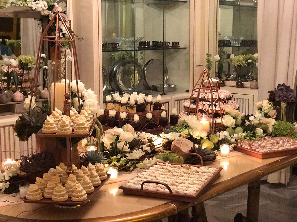 a table with desserts and flowers