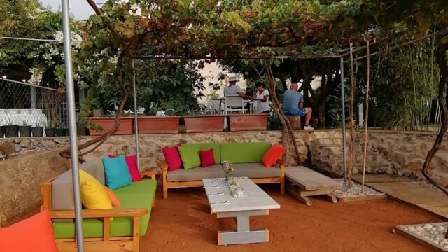 a patio area with a pergola and a table and chairs