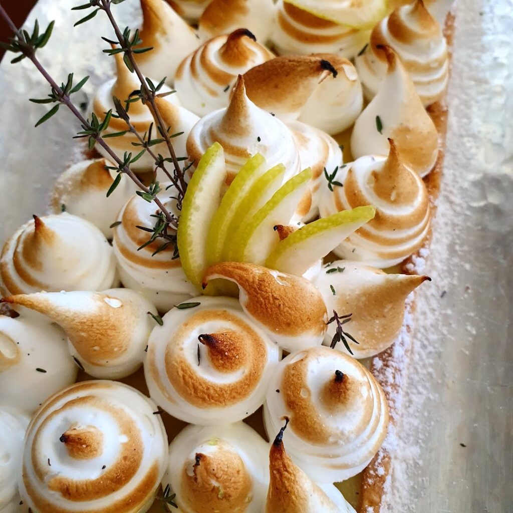 A plate of food from Nazira Catering on a table.