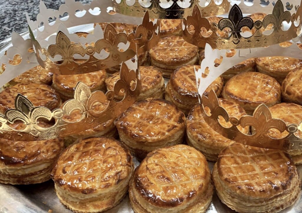 A tray of pastries with crowns from Nicolas Audi Catering SAL.