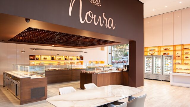 "Noura Downtown is a restaurant with a table and chairs."