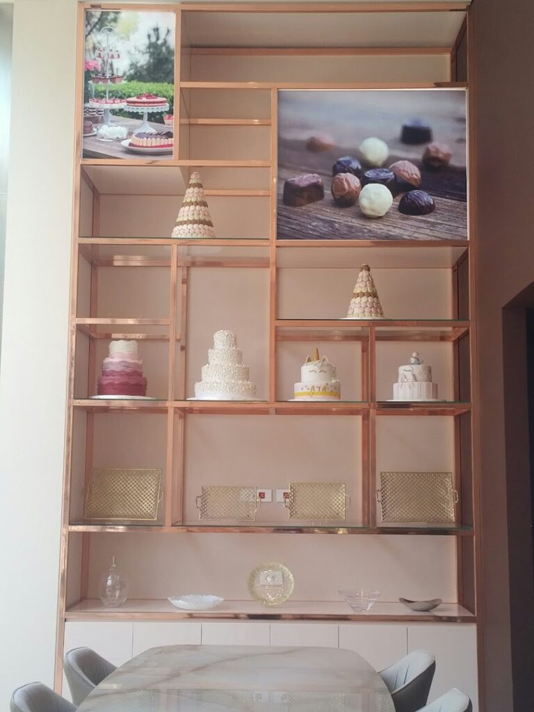 A shelf with cakes on it in Noura Downtown.