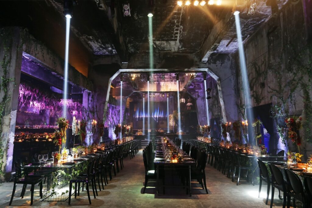 a room with tables and chairs with purple lights