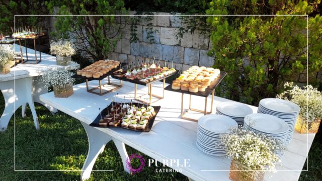 A table with food on it set up by Purple Catering & Events.
