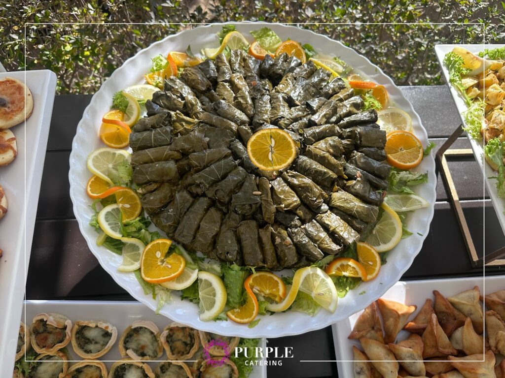 A plate of food from Purple Catering & Events on a table.