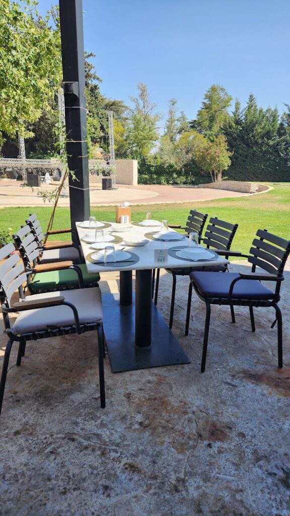 A table with plates and chairs outside at Sama Chtaura.