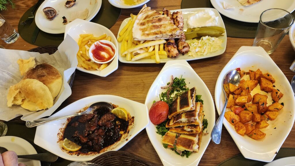 A table with plates of food featuring "Sama Chtaura."