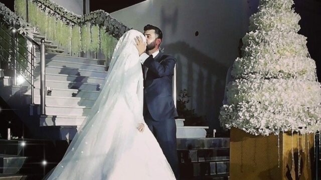 a man and woman kissing on stairs