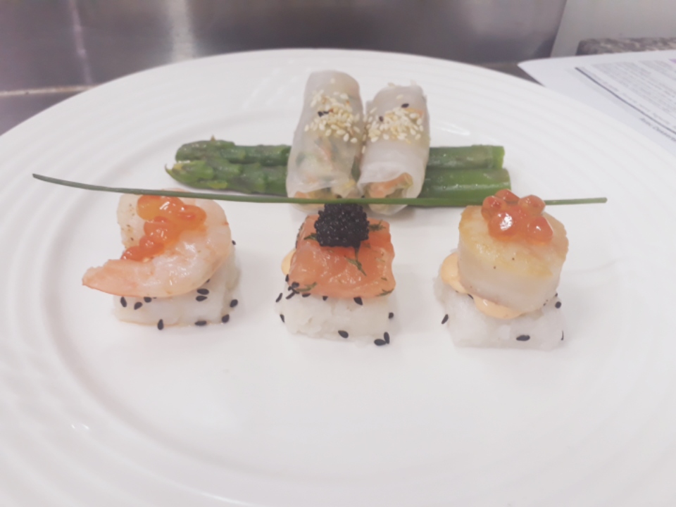 "A plate of sushi from Saveur Plus Catering on a table."