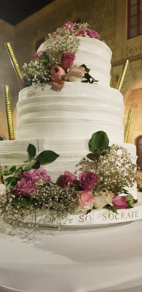 A cake with flowers on it from Socrate Catering.