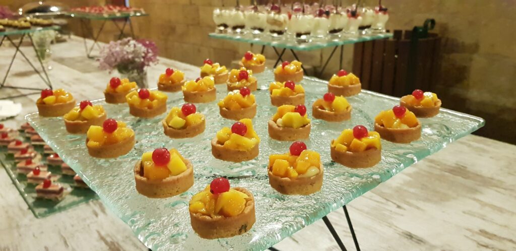 Socrate Catering serves a tray of fruit tarts.
