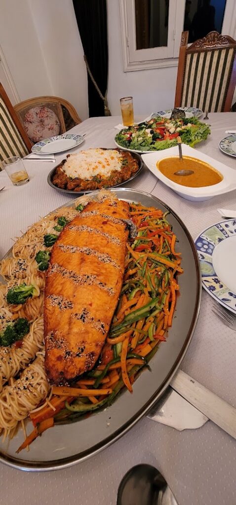 "A plate of food from Socrate Catering on a table."