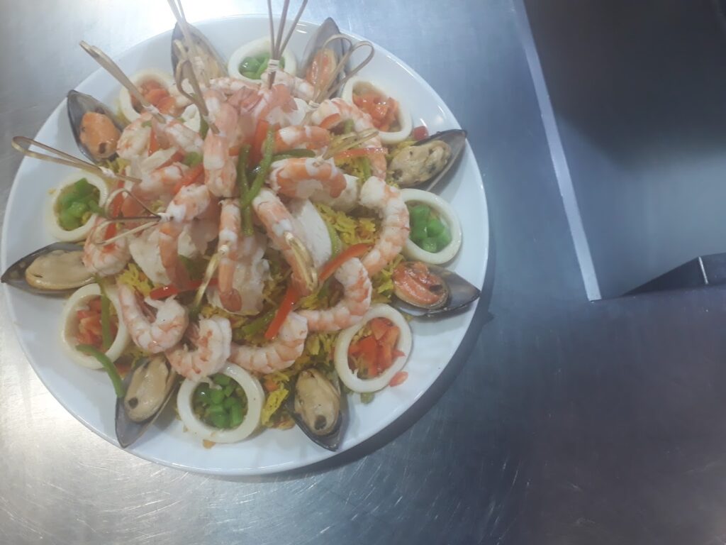 "A plate of seafood on a metal surface, served by Socrate Catering."