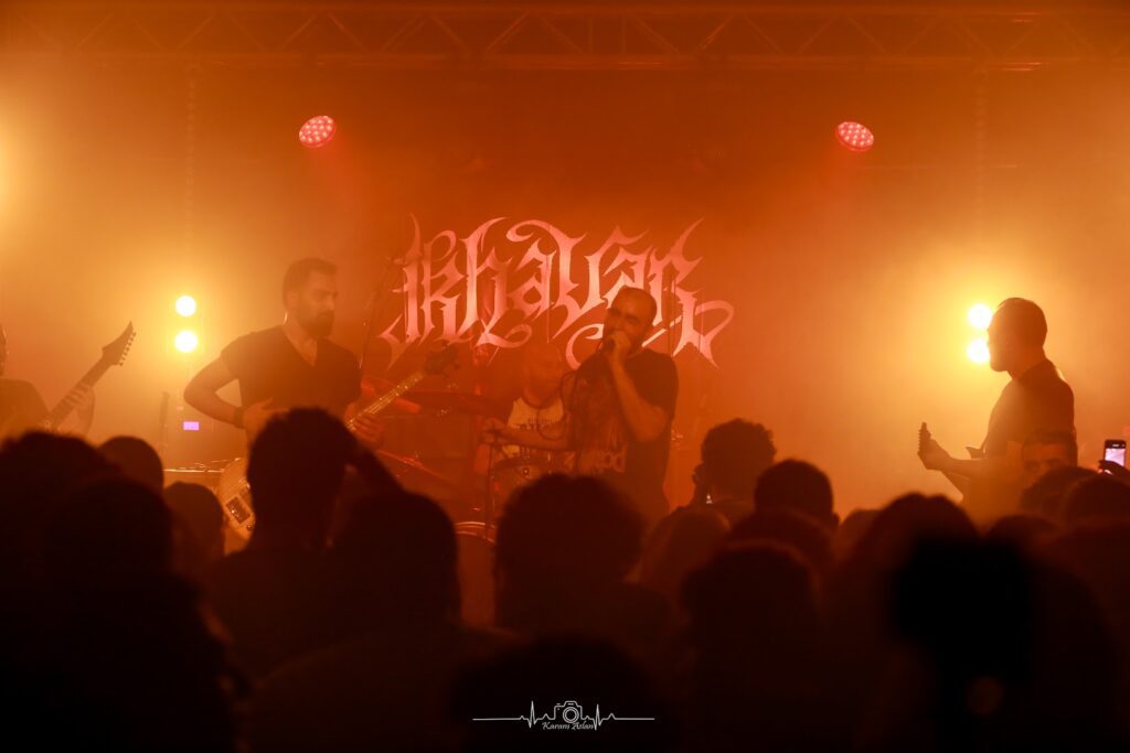 a group of men on a stage with a crowd watching