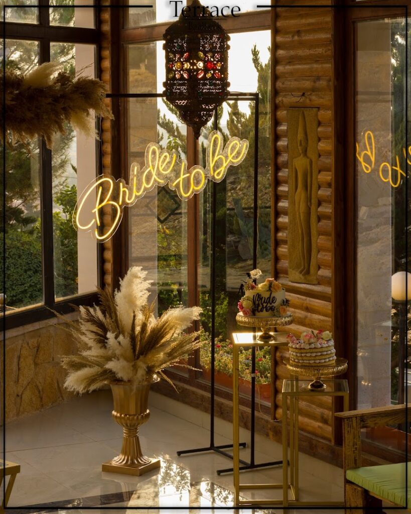 A glass door with a sign and a cake welcomes guests to the Terrace Baalbeck.