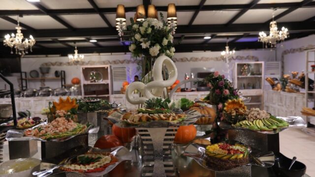 A buffet table with food on it, provided by The Experts Catering and Pastry.